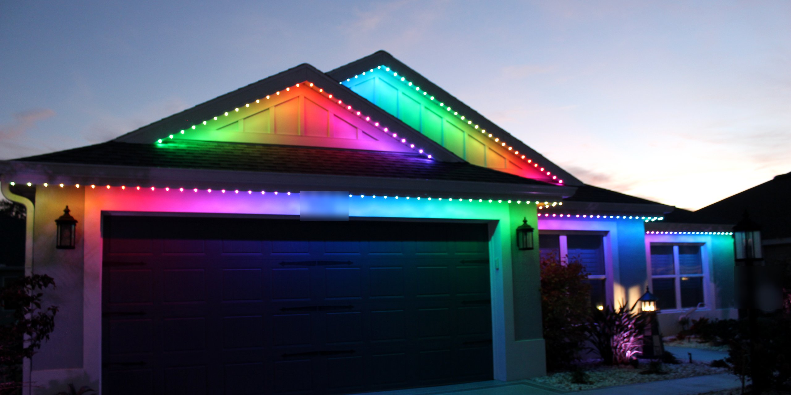 Trimlight 3L permanent roofline lighting showing a full colour gradient on a home in The Villages, Florida